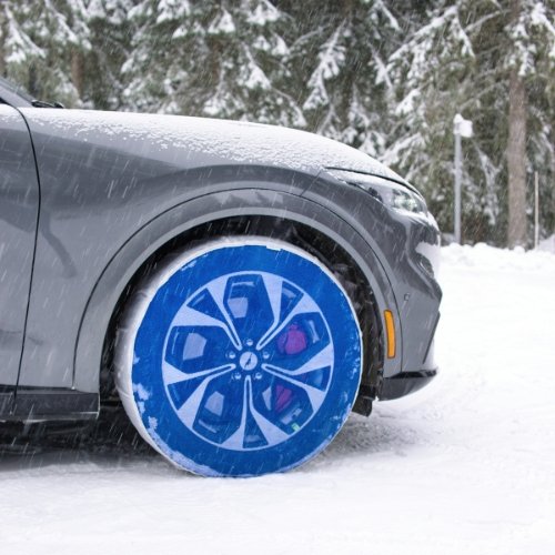 SnowGecko textile traction device mounted on front wheel of a car